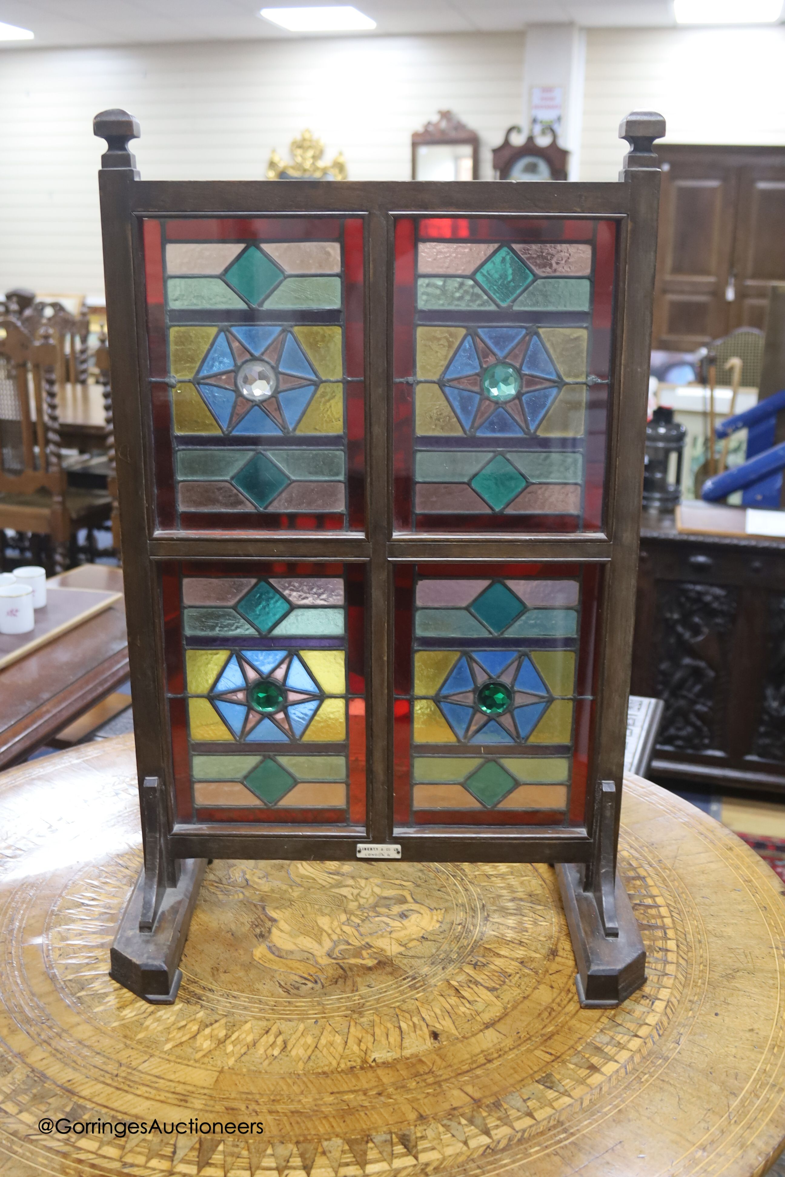 An Edwardian Liberty & Co. stained glass and beech leaded glass room screen, width 43cm, height 67cm